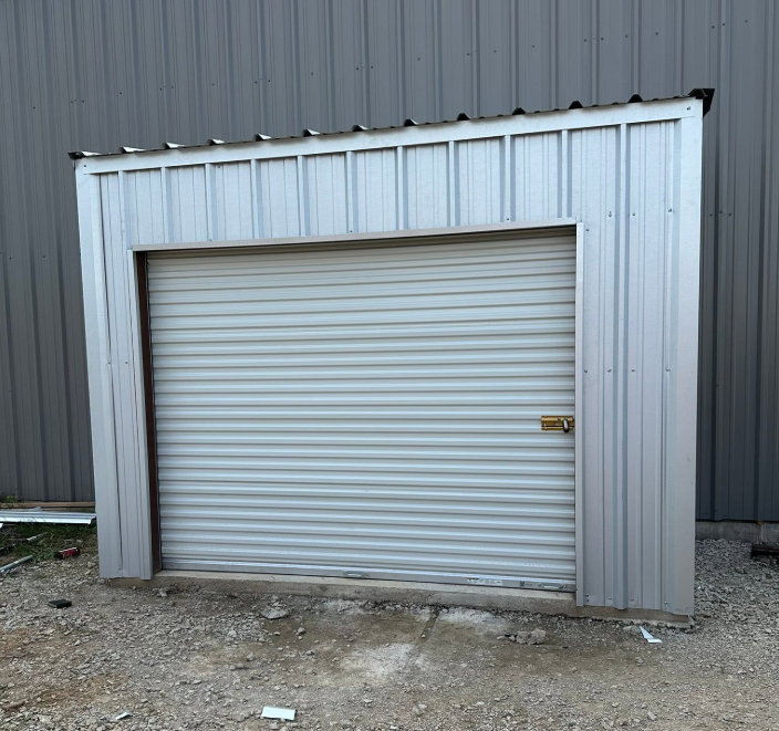 Metal building addition with roll-up door